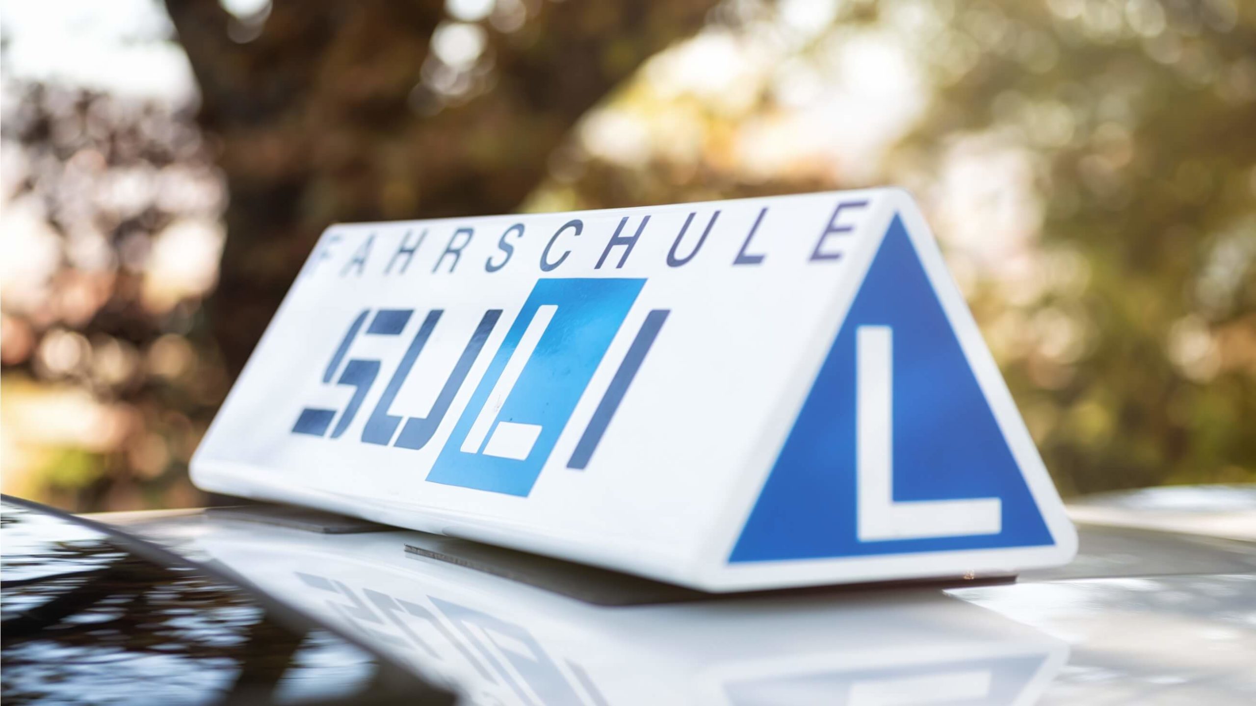 Fahrschulauto mit dem Fokus auf dem 'L' für Lernfahrer.
